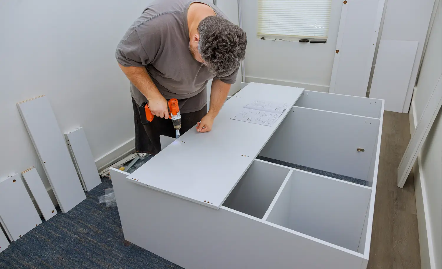 Carpenter working on custom kitchen furniture installation